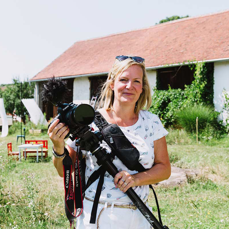 Image of Emma Wilson, Wedding videographer on a shoot holding camera