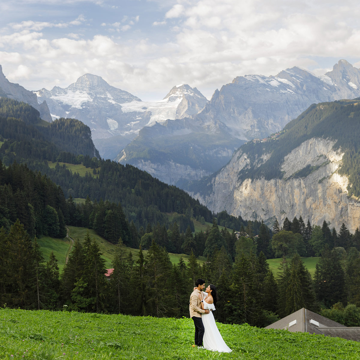 A bride and groom embrace after their elopement ceremony in the Mountains above Wengen in the Swiss Alps