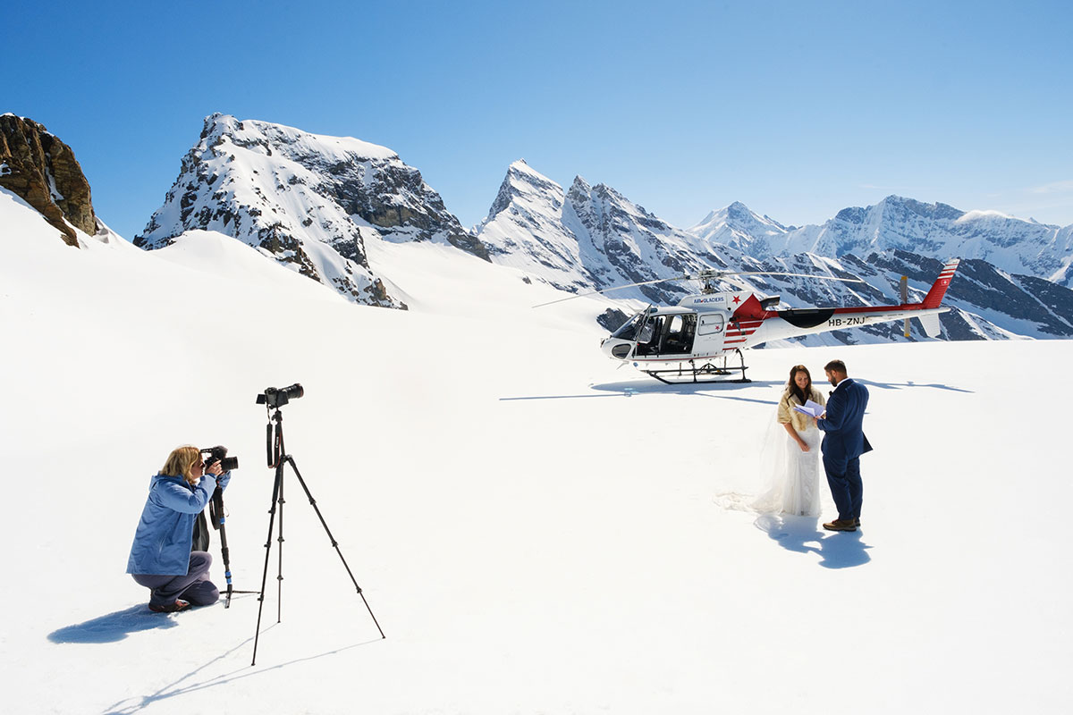Image of a bridge and groom on the Petersgrad glacier being filmed by Emma Wilson from Story of Your Day on their Adventure Elopement