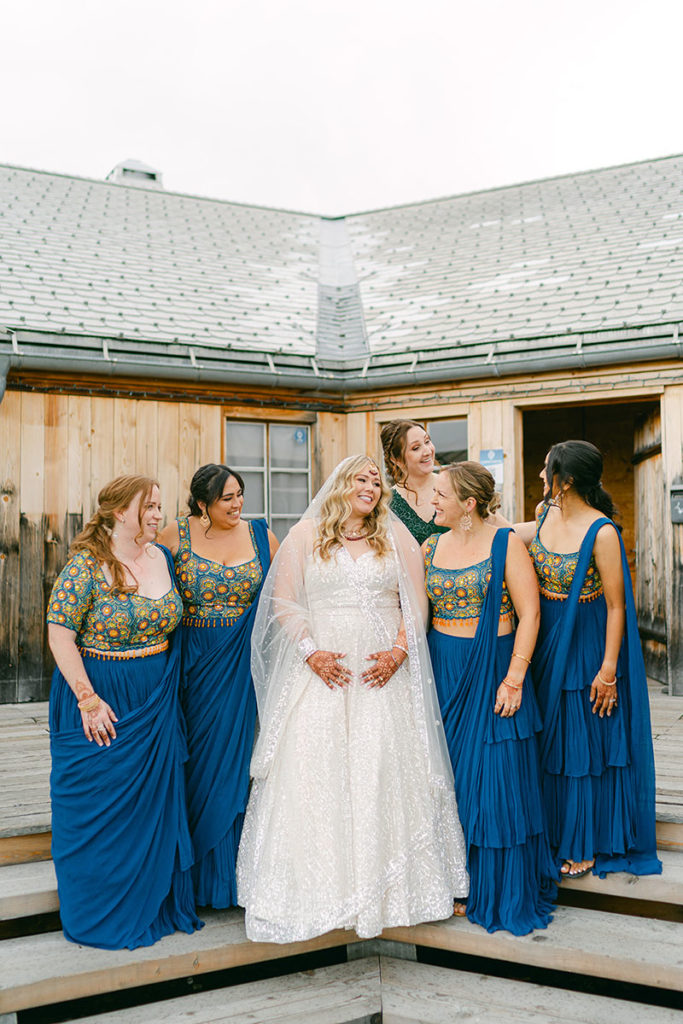 A bride with her bridal party smiling and laughing before her wedding in Lenk